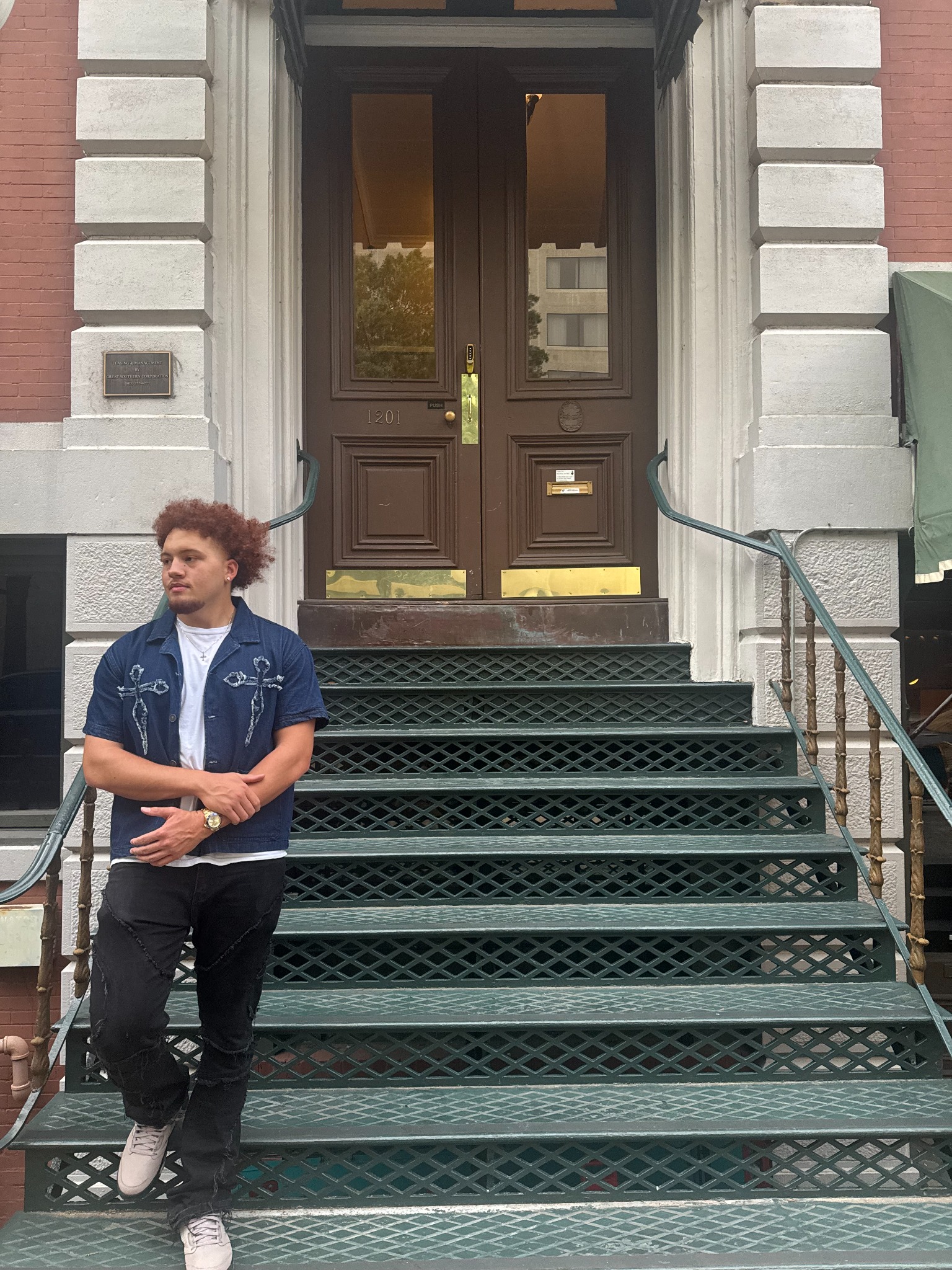 Travis M. Thompson standing on city steps